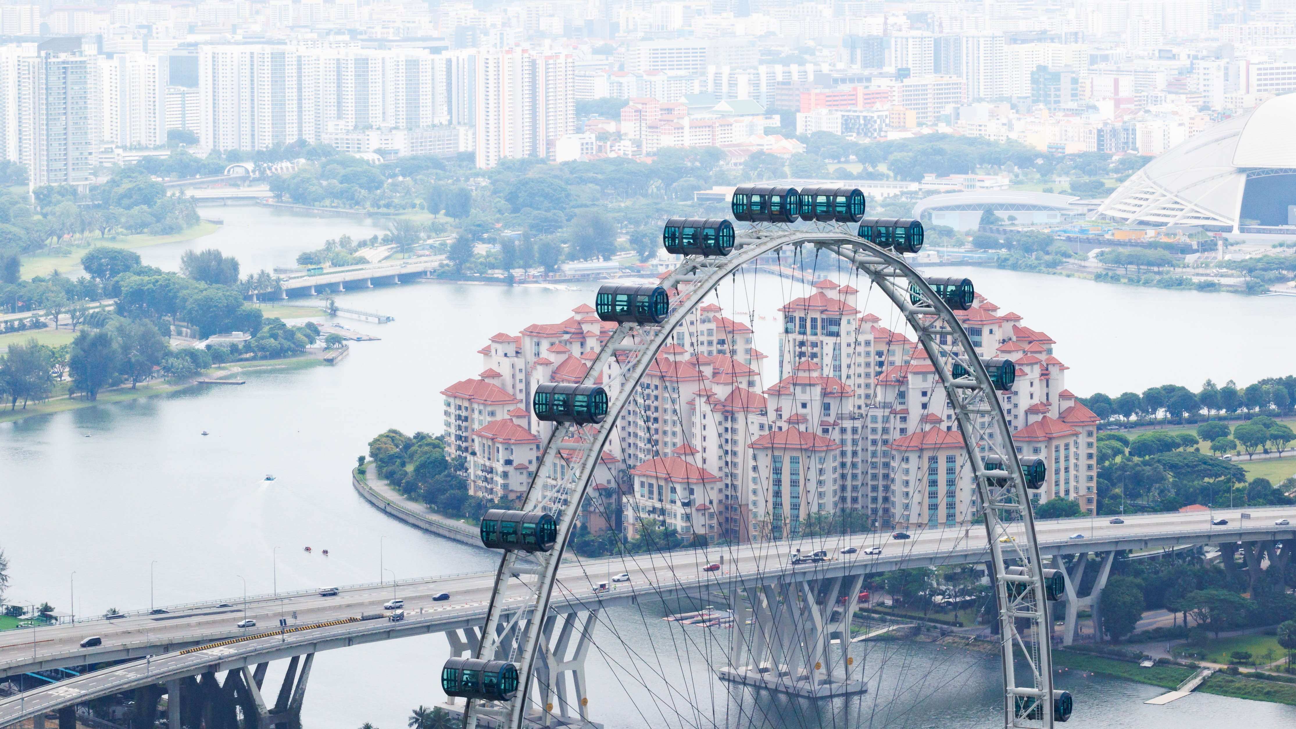 Cityscape of Singapore and ferris wheel seen from Marina Bay Sands Observation Deck.