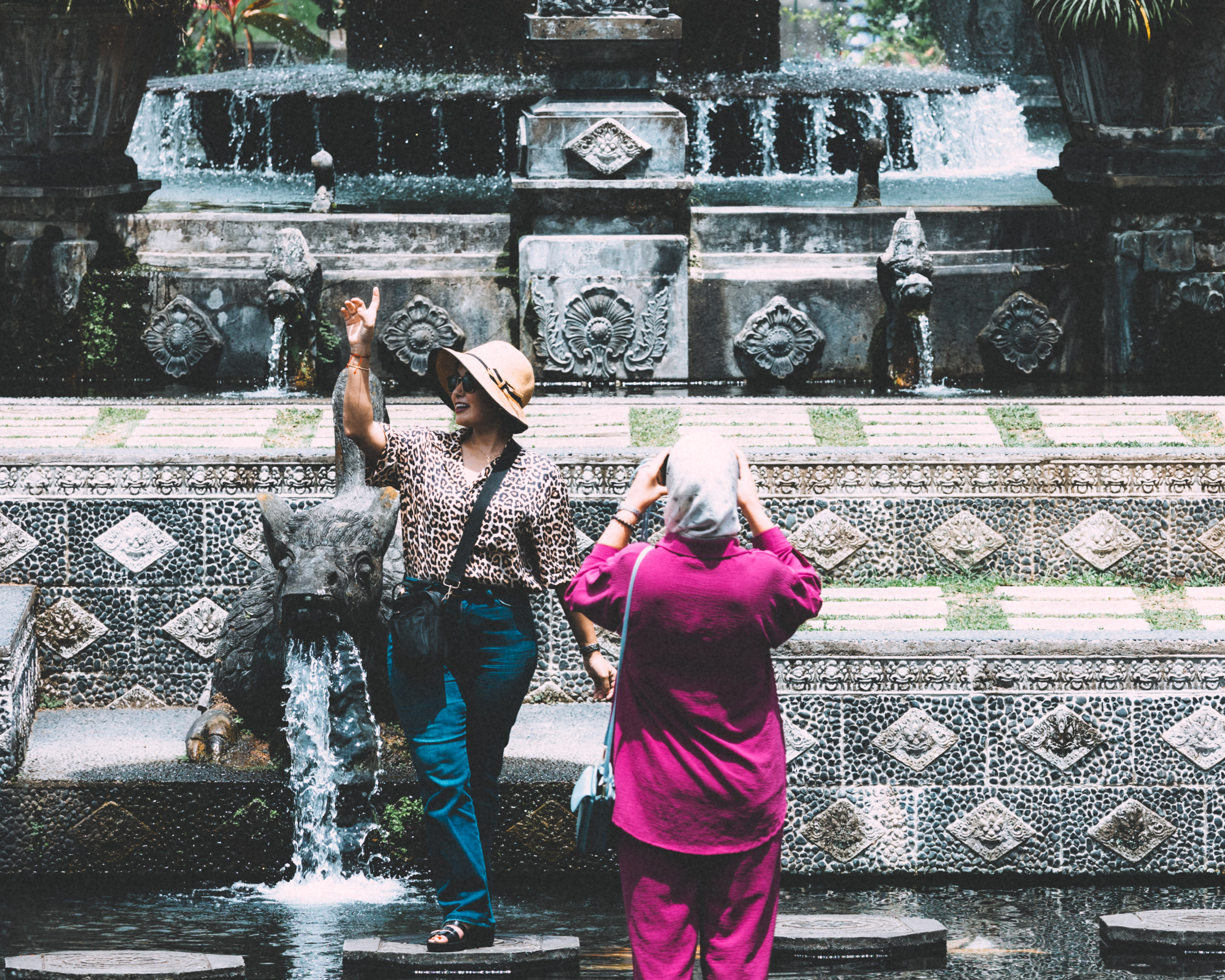 Tourists having a photo session at Tirta Gangga Temple,  The Water Palace, Bali, Indonesia