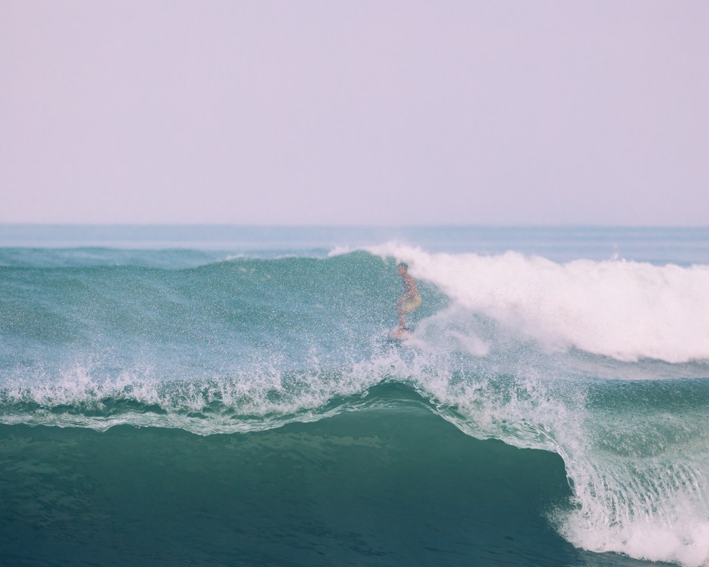 Surfer and waves in Berawa, Canggu, Bali 2022