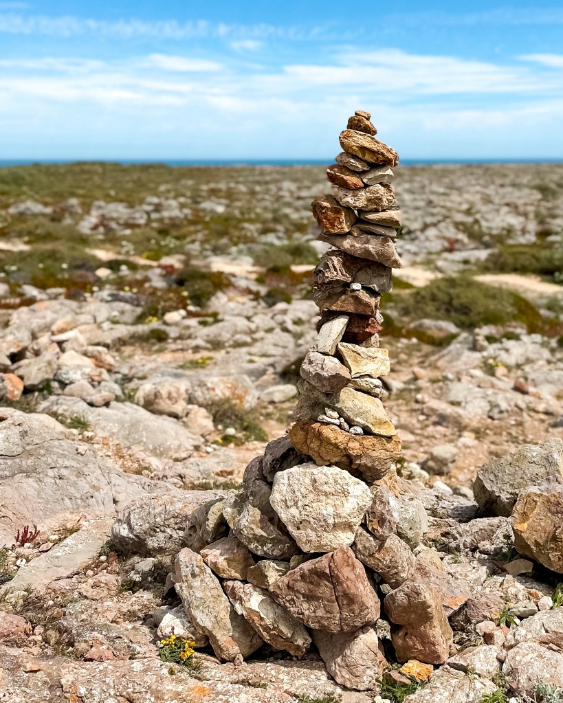 Rocks stapled on top of each other at Farol de Sagres, Algarve, Portugal, April 2023