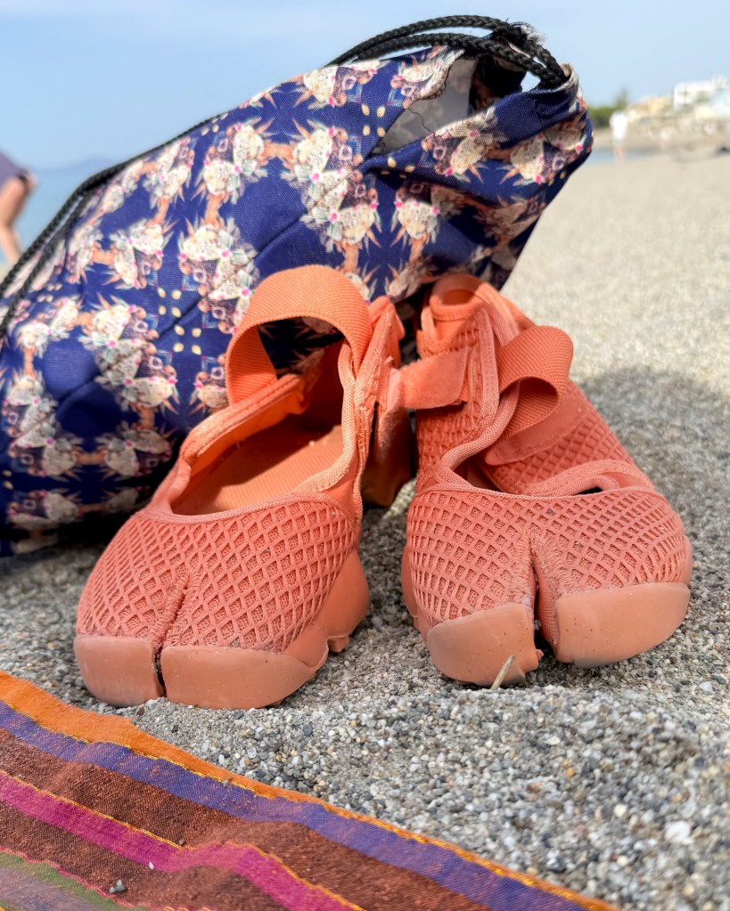 Drawsting bag made by HelenaTheSea.com and Nike Air Rift on Platanias Beach in Crete, Greece May 2025
