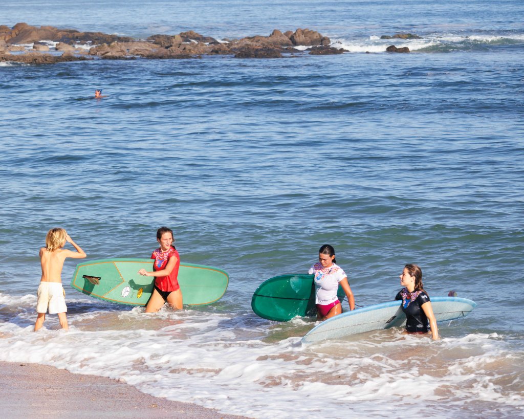 Female surfers exiting the sea at Playa Los Pintos, Mexi Log Fest, Mazatlán, Mexico