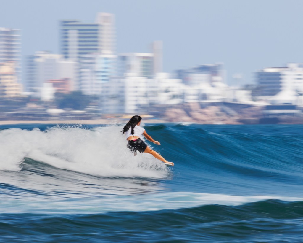 Female surfer at Playa Los Pintos, Mexi Log Fest, Mazatlán, Mexico
