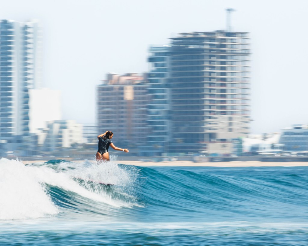 Female surfer at Playa Los Pintos, Mexi Log Fest, Mazatlán, Mexico