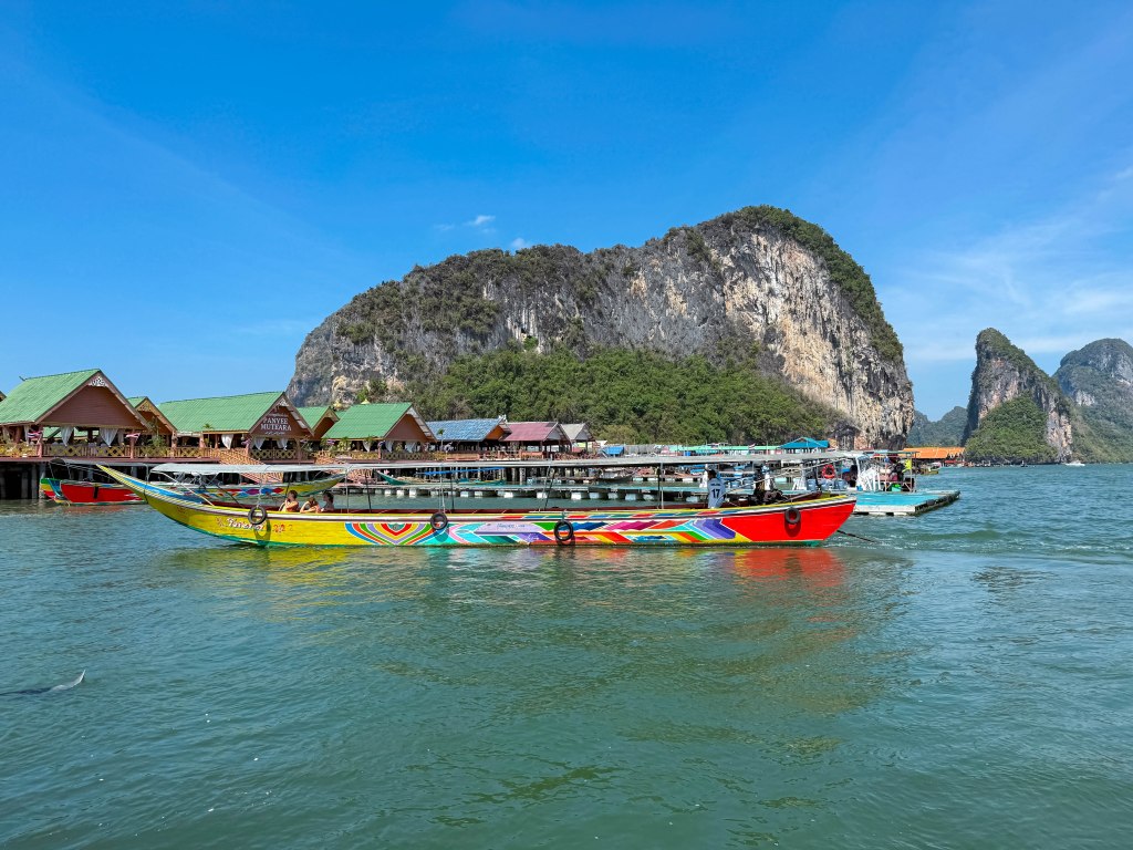 Thai longboat outside Koh Panyee in Phang Nga Bay, Thailand, which is fishing village built entirely on stilts by Muslim fishermen. January 2026