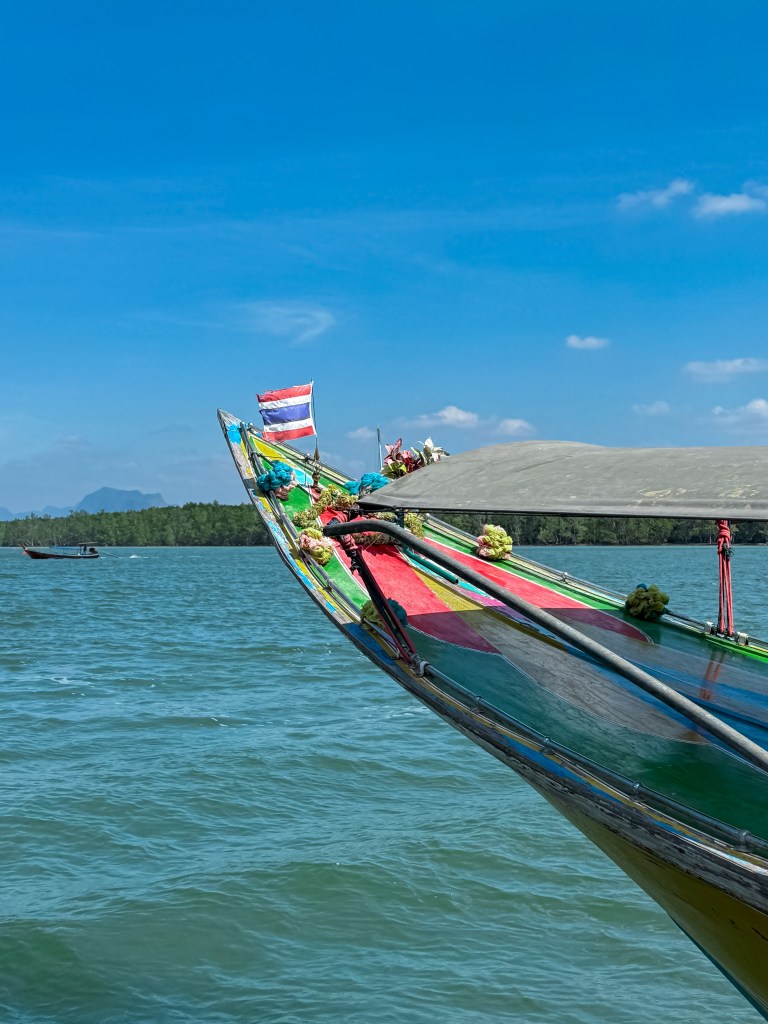Thai longboat outside Koh Panyee in Phang Nga Bay, Thailand, which is fishing village built entirely on stilts by Muslim fishermen. January 2026