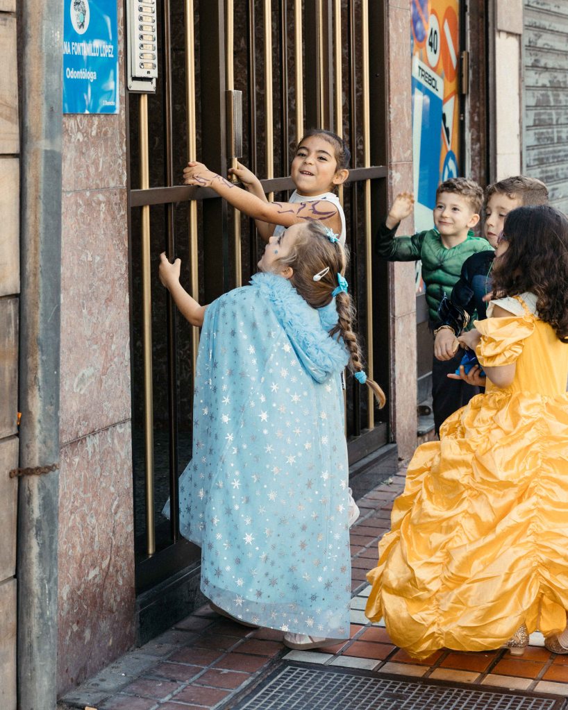 Children playing at a doorway before the Childrens Carnival parade in Las Palmas, Gran Canaria, Spain February 2026