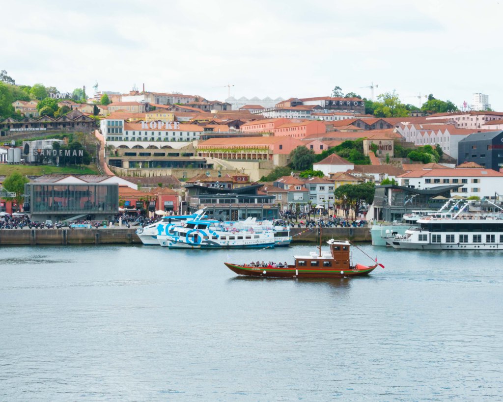 Boats on The Douro River and the Sandeman Port Cellar and winery, Porto, Portugal