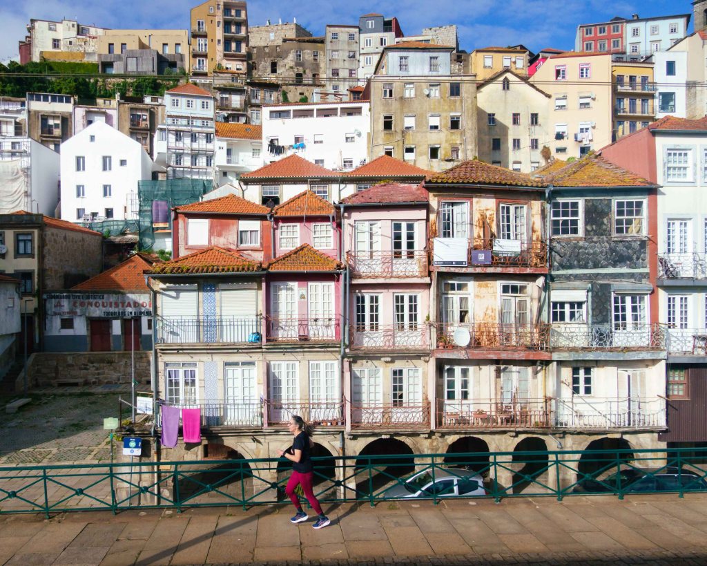 City scape of Porto, woman jogging on the street, Portugal